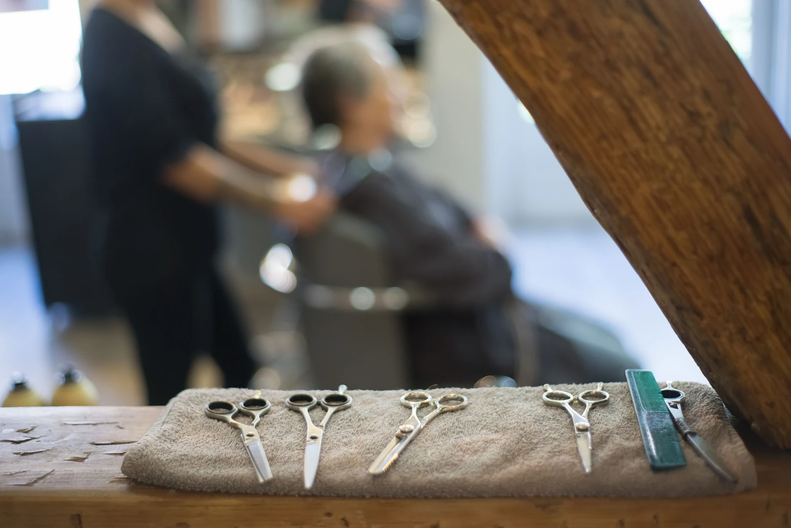 Scissors and a comb on a clean towel in a working barbershop.